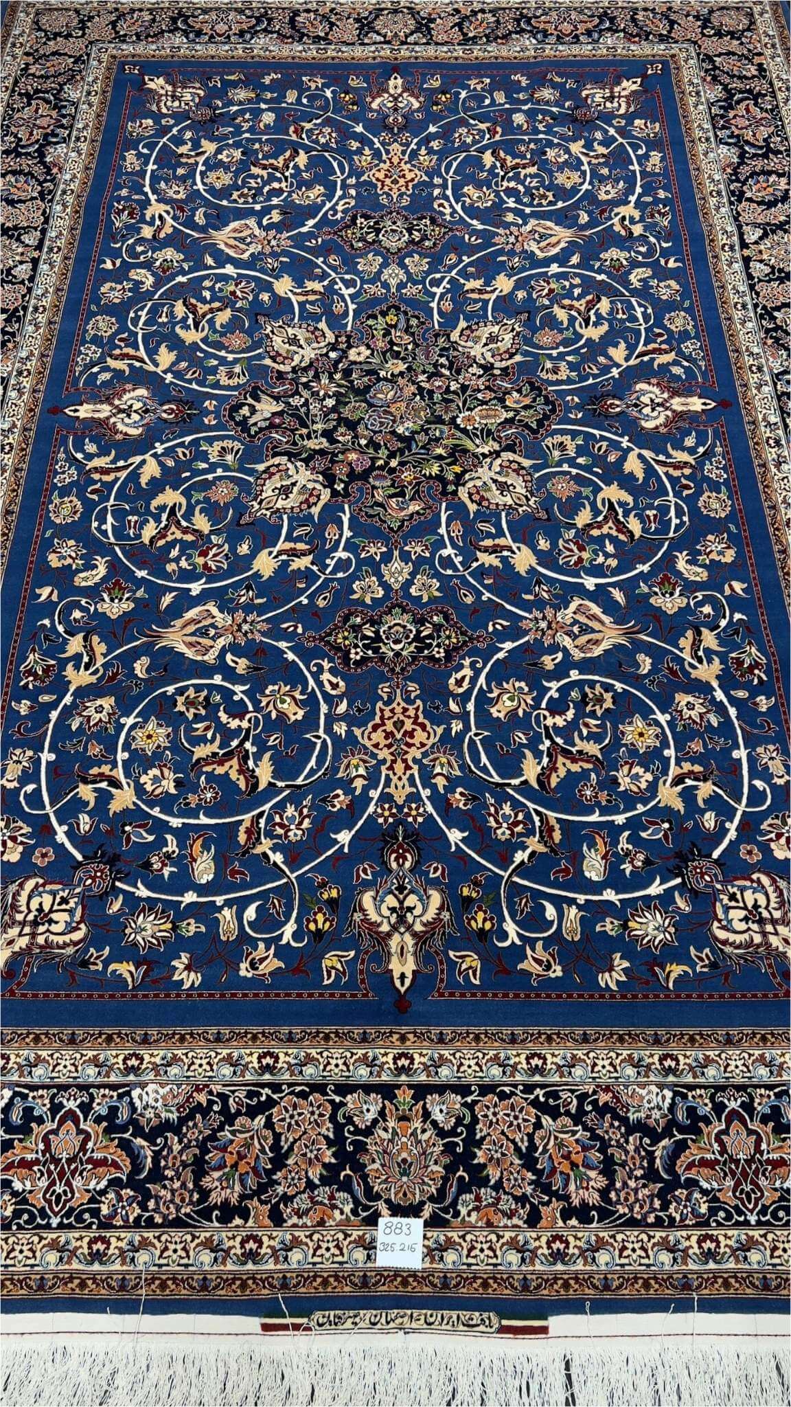 "Hand-knotted blue Persian rug by Master Bagher Seirafian with floral designs."